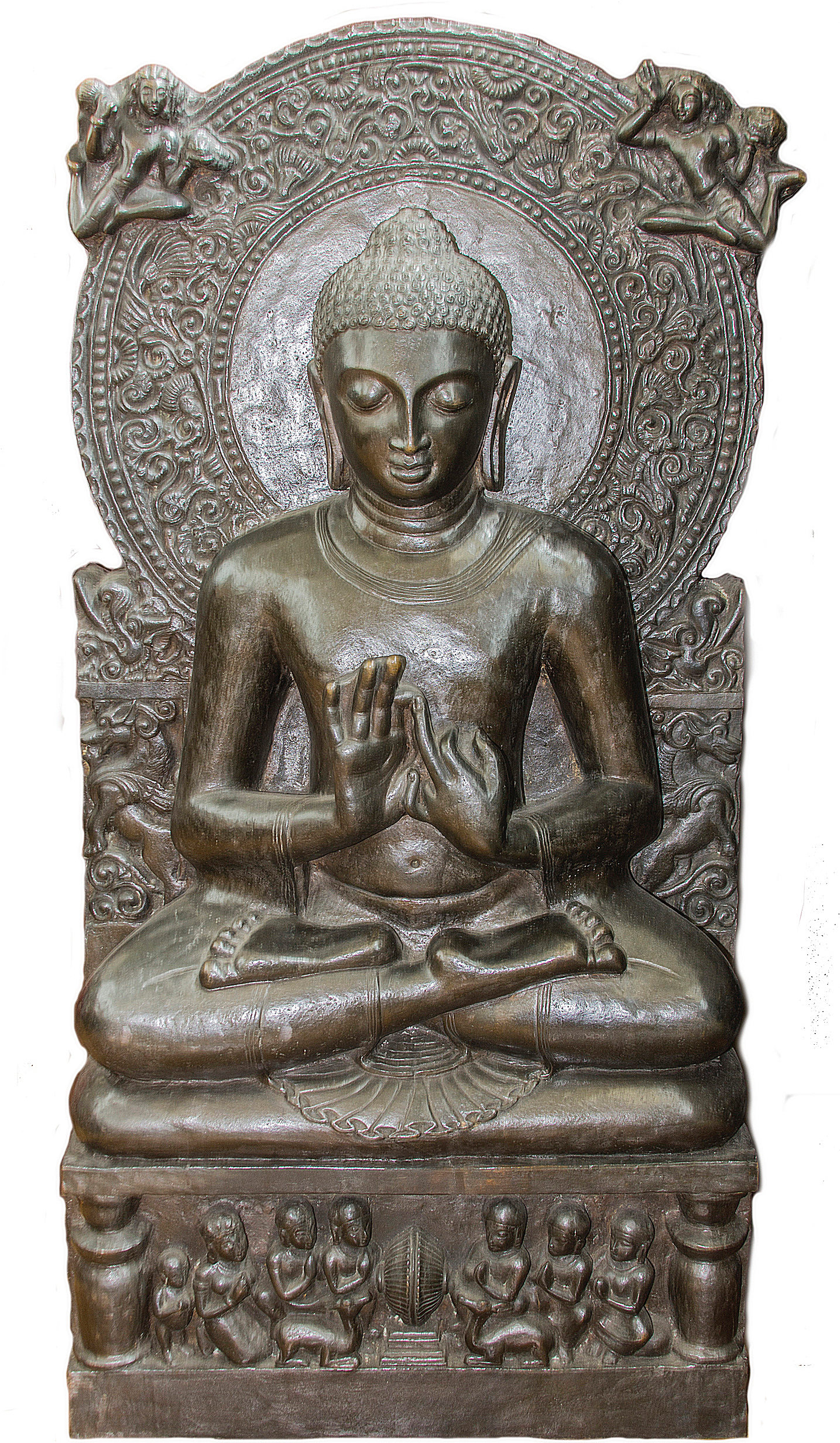 Escultura en bronce de Buda sentado en posición de loto con los ojos entrecerrados en meditación, posee un halo circular detrás de su cabeza con dos figuras volando. Abajo, un basamento rectangular con siete figuras humanas y dos animales.